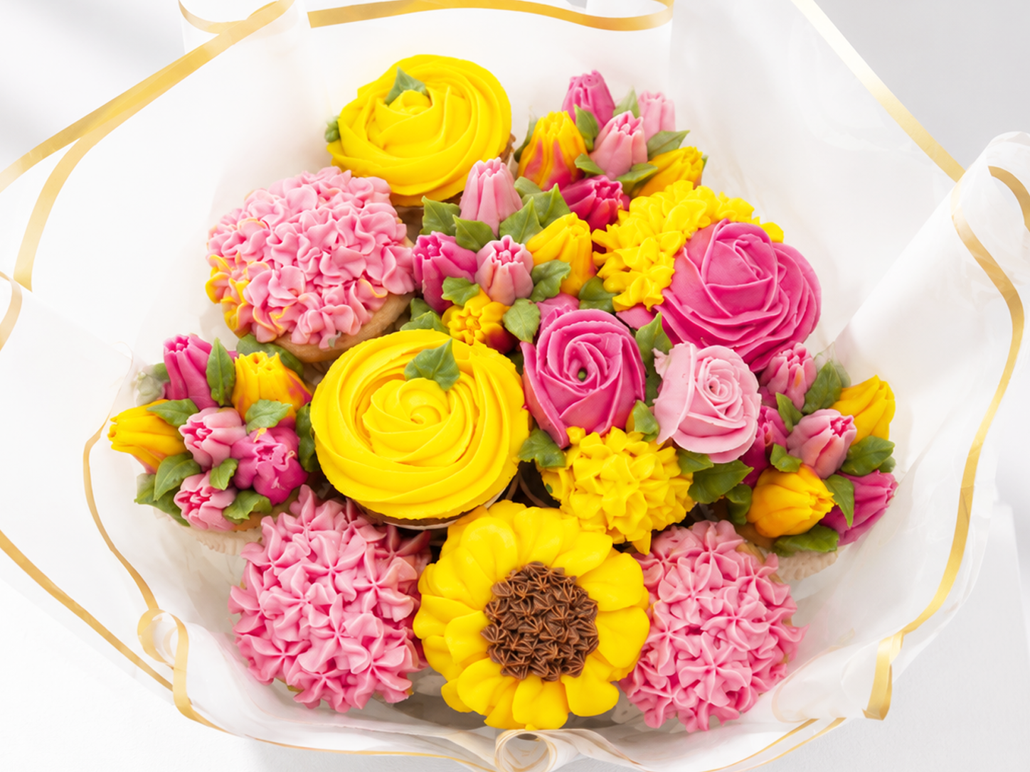 Close-up of Pink and Yellow cupcake bouquet, handmade cupcakes UAE